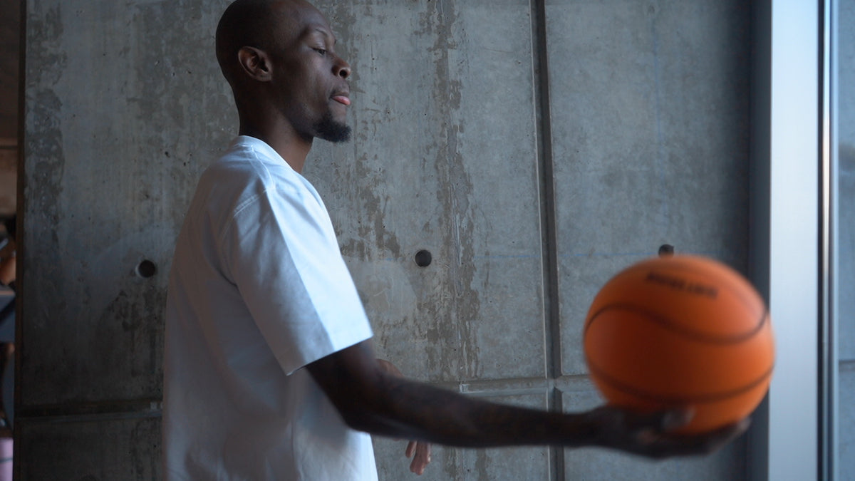 Taze Moore holding a QBounce Silent Basketball