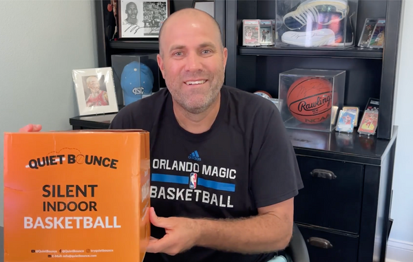 Customer holding the QBounce silent basketball box