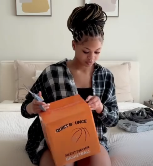 Customer opening the QBounce silent basketball box